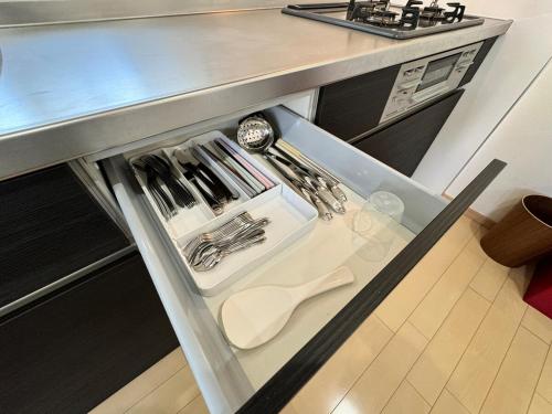 a drawer in a kitchen with utensils at 白浜温泉付き貸別荘b-72 in Shirahama