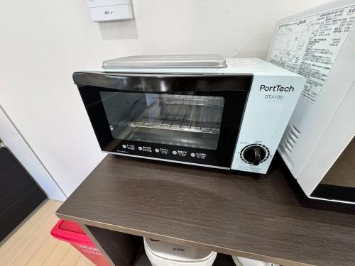 a toaster oven sitting on top of a table at 白浜温泉付き貸別荘b-72 in Shirahama
