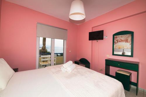a pink bedroom with a bed and a television at La Casa Di Nonna Anna in Nikiana