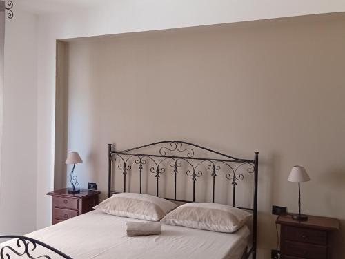 a bedroom with a large bed with white sheets and pillows at Finestra sul Mare di Alessandro in Balestrate