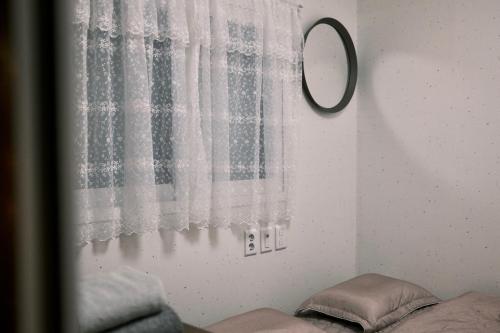 a mirror on a wall next to a window at Villa de Mory in Daegu