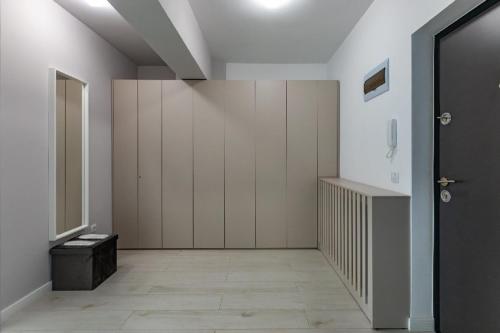 a hallway with white walls and a black door at Rezidential Park Letea by Rooms in Bacău