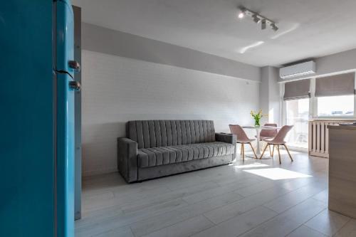 a living room with a couch and a table at Rezidential Park Letea by Rooms in Bacău