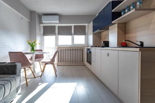 a kitchen with a couch and a table in a room at Rezidential Park Letea by Rooms in Bacău