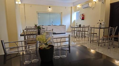 a large room with chairs and a table with flowers at kangaroo hotel in Bumlitan