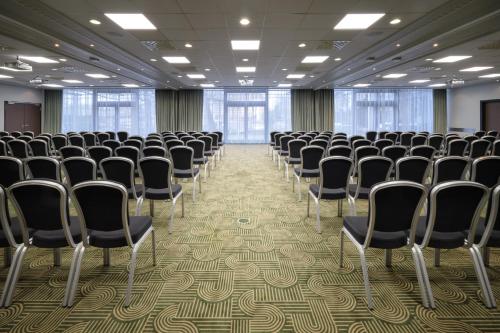 a room with rows of chairs in a hall at NYX Hotel Berlin Köpenick by Leonardo Hotels in Berlin