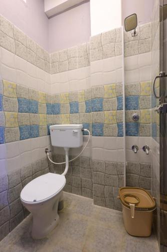 a bathroom with a toilet and a shower at Nautical Escape Home Stay in Puducherry