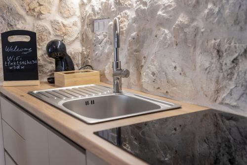 a kitchen sink in a counter top with a cutting board at G&J Minimal House in Tríkala