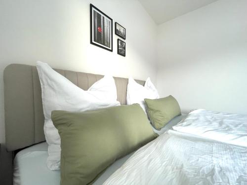 a bedroom with a bed with white sheets and pillows at wanderlutz in Baiersbronn