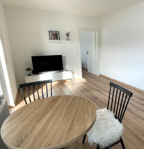 a living room with a table and a television at wanderlutz in Baiersbronn