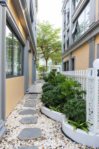 a walkway in front of a building with plants at Family Villa - Phu Quoc Island in Phu Quoc