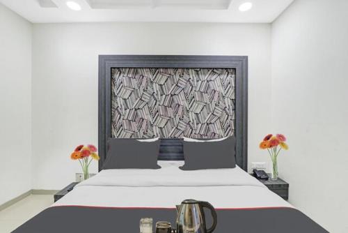 a bedroom with a large bed with a window at Hotel Pearl Villa in Ahmedabad