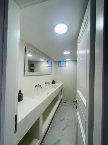a bathroom with a large sink and a mirror at 2-bedroom LOFT apartment in Megali Ammos