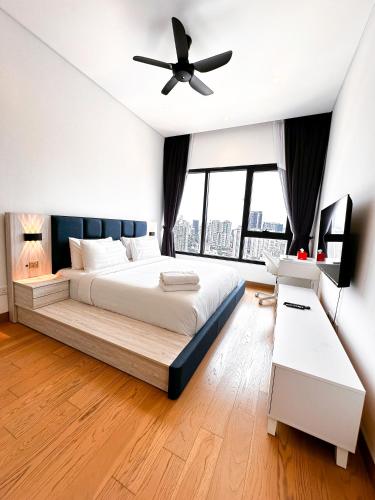 a bedroom with a bed and a ceiling fan at Lucentia Residence by EAS Maju property in Kuala Lumpur