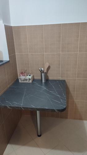 a blue counter top in a corner of a room at V&J apartments in Podgorica