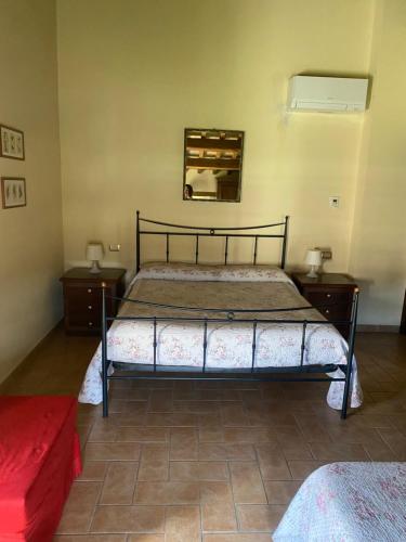 a bedroom with a bed and a mirror on the wall at Parco Ducale Country House in Urbania