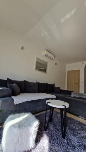a living room with a couch and a table at Apartman Magdalena in Kastel Stafilic
