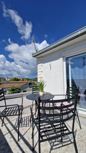 a black table and chairs on a patio at Apartman Magdalena in Kastel Stafilic
