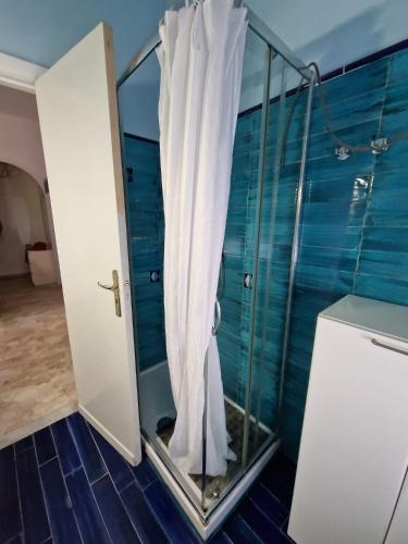 a shower with a white curtain in a bathroom at Casa Cristina in Maiori