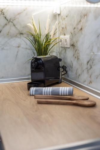 a wooden table with a knife and a comb and a plant at Houseloft White Tower Icon in Thessaloniki