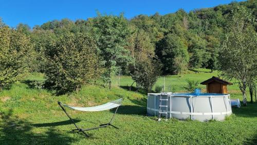 a boat and a hammock in a field at Apartma Patricija - big apartment for 6 in Tolmin