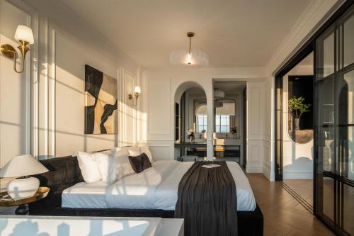 a bedroom with a bed and a living room at Mello Hotel in Shenzhen