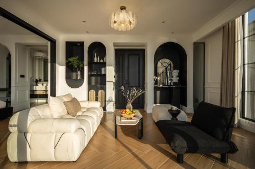 a living room with a white couch and a chair at Mello Hotel in Shenzhen