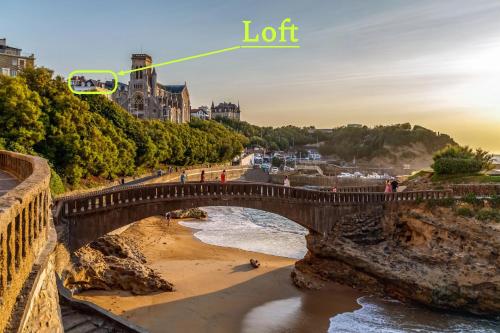 a bridge over a beach with the words lot at Magnifique loft au-dessus de l'océan, place de parking in Biarritz