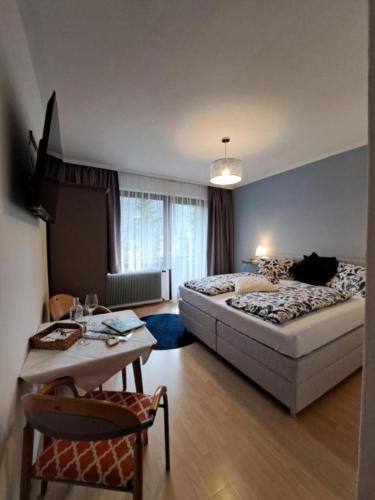 a bedroom with a large bed and a table and a table sidx sidx at Haus Zedlacher in Patergassen