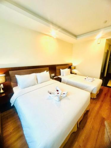 Postel nebo postele na pokoji v ubytování Muong Thanh Vinh Hotel