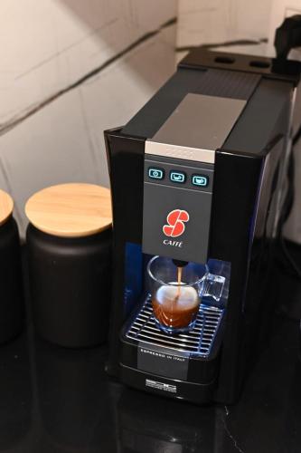 a coffee maker on a table with a cup of coffee at Studio Hagalil in Tiberias
