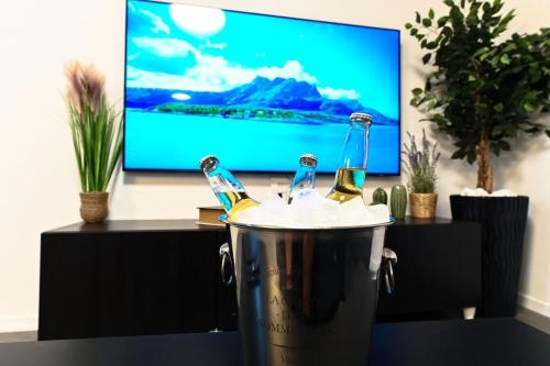 two bottles of beer in a bucket in front of a tv at Loft Hagalil in Tiberias