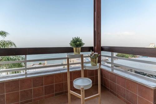 a balcony with a chair and a view of the ocean at Kinneret View Six Bedrooms in Tiberias