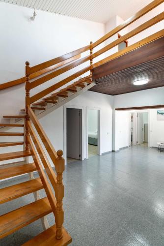 a wooden staircase in a building with a room at Kinneret View Six Bedrooms in Tiberias
