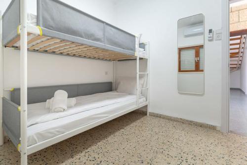 a room with two bunk beds with a mirror at Kinneret View Six Bedrooms in Tiberias