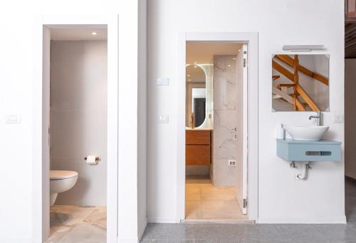 two views of a bathroom with a sink and a toilet at Kinneret View Six Bedrooms in Tiberias