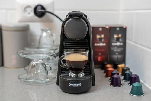 a coffee maker on a counter with a cup of coffee at Michaelangelo Luxury Garden Apartment with Private Pool in Tiberias