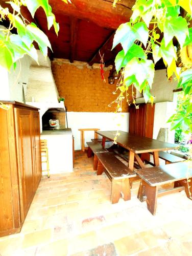a patio with a picnic table and a stove at Gamm Simius Home Holiday in Villasimius