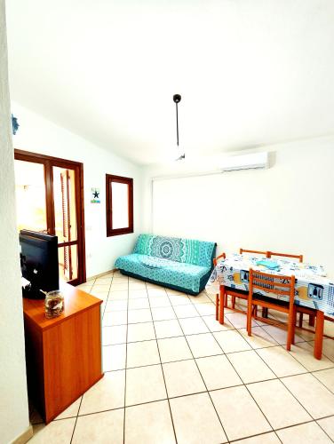 a living room with a couch and a table at Gamm Simius Home Holiday in Villasimius