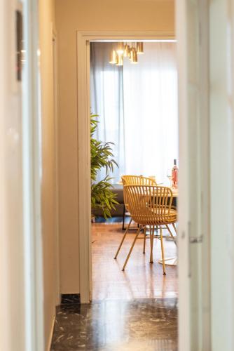 a dining room with a table and a chair at Houseloft White Tower Icon in Thessaloniki
