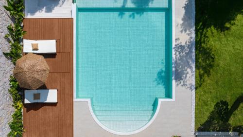 an overhead view of a swimming pool with two chairs at Mello Hotel in Shenzhen