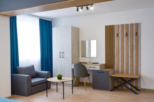 a living room with a chair and a desk at Danchev Hotel in Slivo Pole