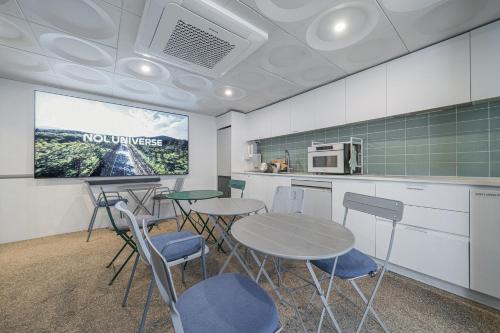a room with tables and chairs in a kitchen at SimpleStay Hotel in Jongno in Seoul