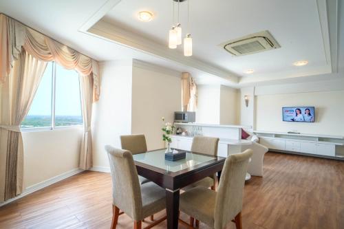 a dining room with a table and chairs at Thong Tarin Hotel in Surin