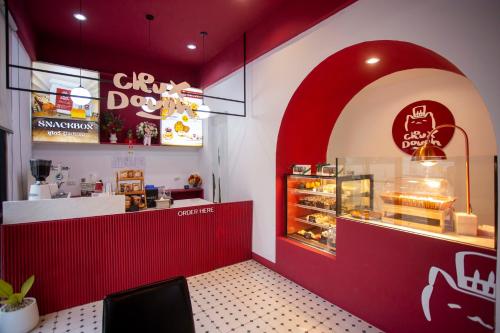 a fast food restaurant with a red wall at Thong Tarin Hotel in Surin