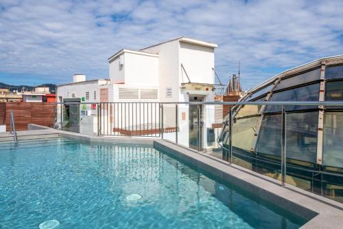 a swimming pool on the roof of a building at Gran Hotel Havana 4Sup by Escampa Hotels in Barcelona