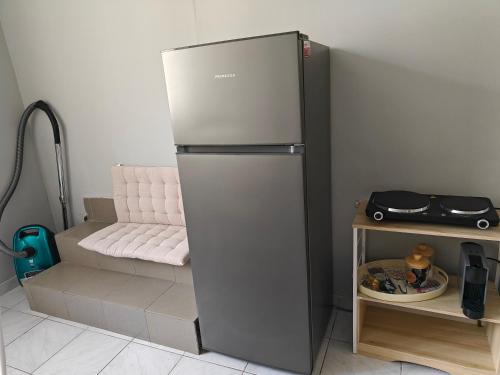 a refrigerator sitting in a kitchen next to a table at Stefani retro luxury apartments in Chalkida