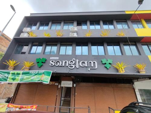 a building with a sign on the front of it at Songtam Hotel in Ipoh