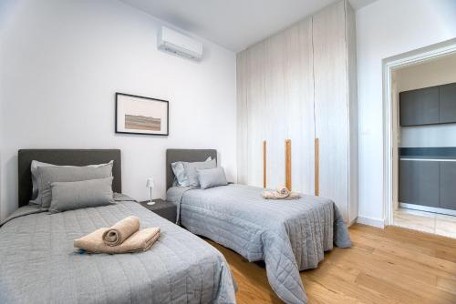 a bedroom with two beds with pillows on them at Prestige 401 2 BED in Paphos