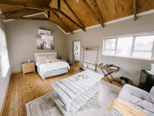 a bedroom with a bed and a couch at Cabins Sodwana Bay - antibootika in Sodwana Bay